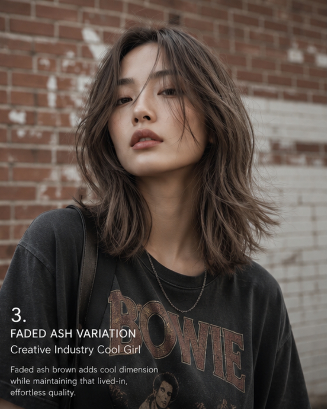 Asian woman in vintage band tee with faded ash brown lived-in texture against a brick wall